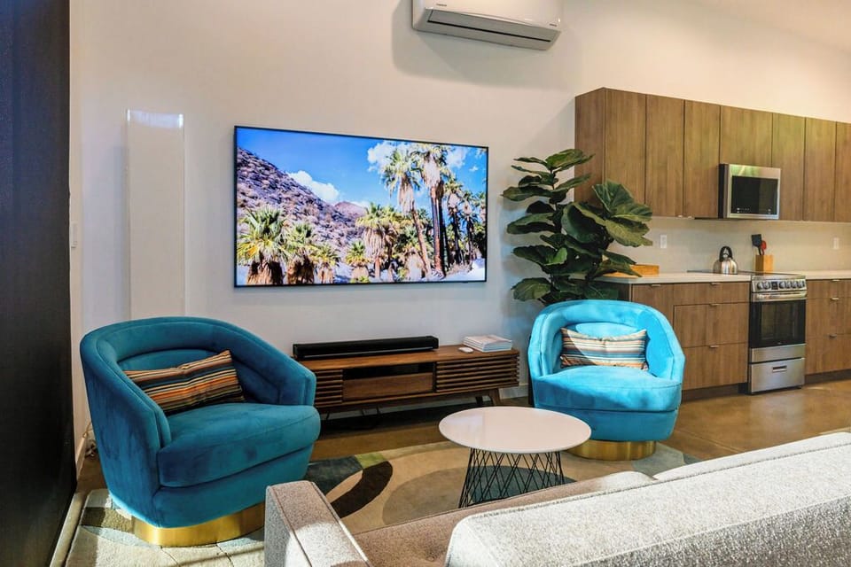 Thoughtfully designed living space featuring a Samsung Frame TV, Sonos soundbar, and comfortable seating for relaxing after a day in the Palm Springs sun.