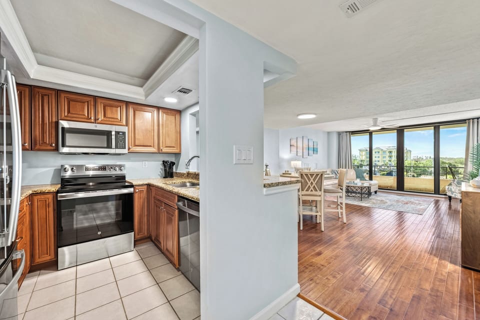 From the kitchen's sunny workspace, your eyes drift effortlessly into the spacious living area—where comfort meets coastal charm, and every moment feels connected.