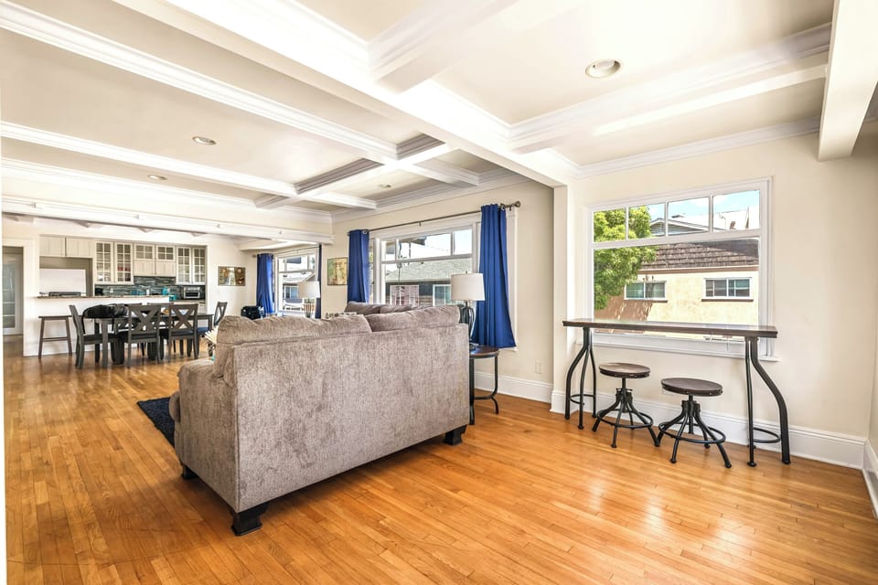Sunlit open-plan living with coffered ceilings and modern kitchen.