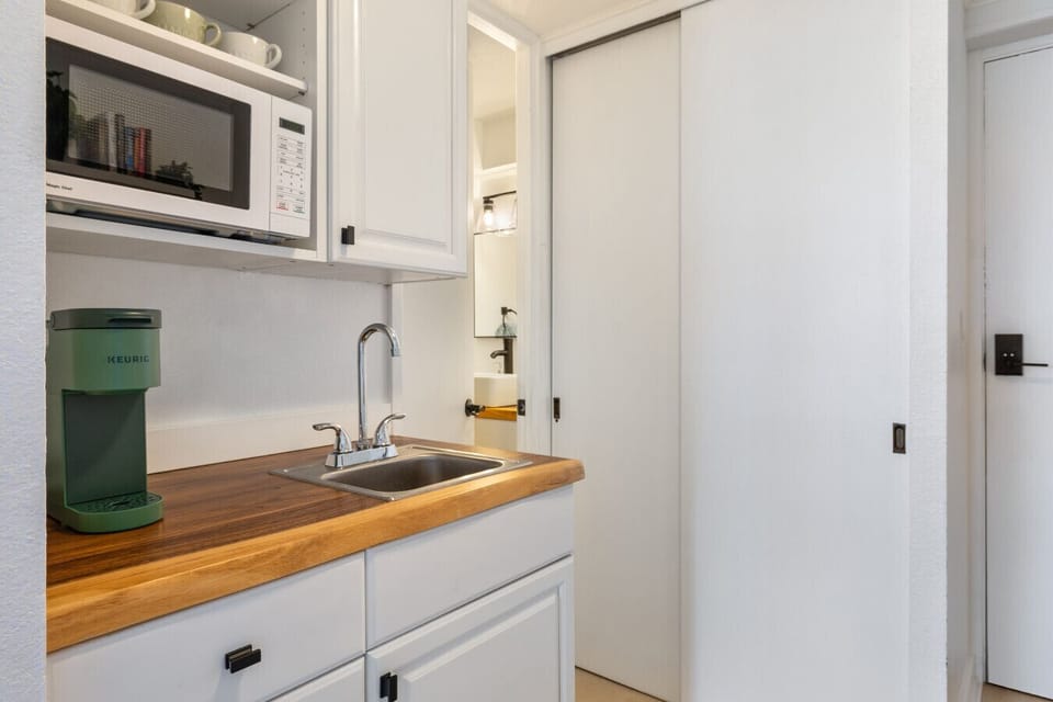 Wake up to coffee at your fingertips with the Keurig, and enjoy the convenience of a microwave for easy snacks.