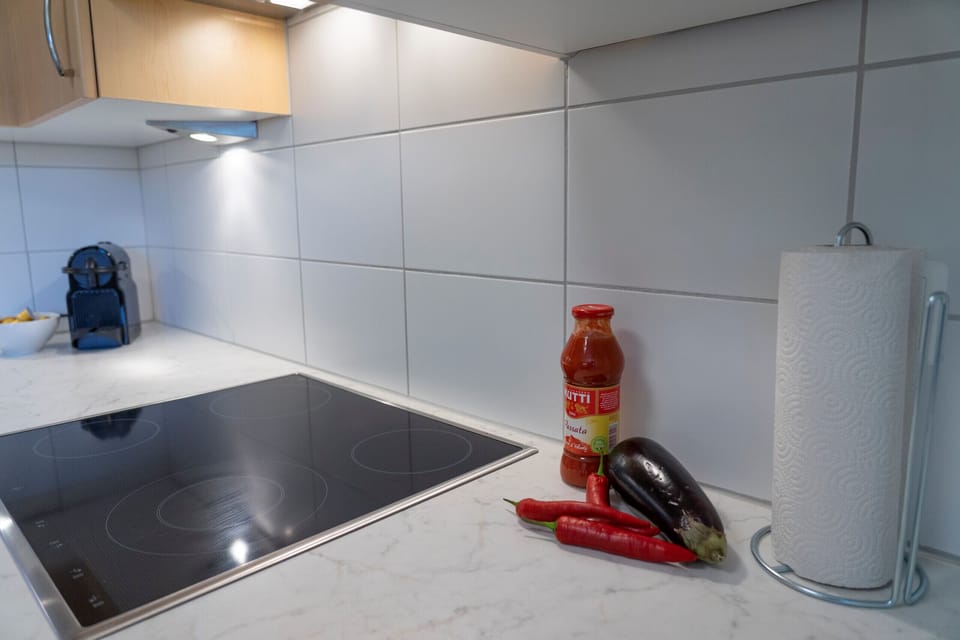 Hob with a coffee capsule machine and fresh vegetables