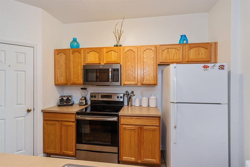Kitchen with stainless steel appliances and oak cabinetry for a functional cooking space