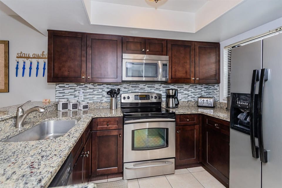Modern kitchen with stainless steel appliances and granite countertops
