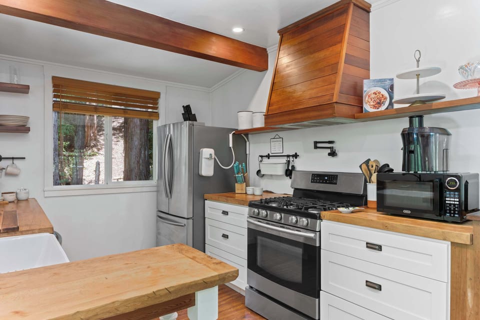 Gas range and stainless steel appliances round out the charming kitchen. 