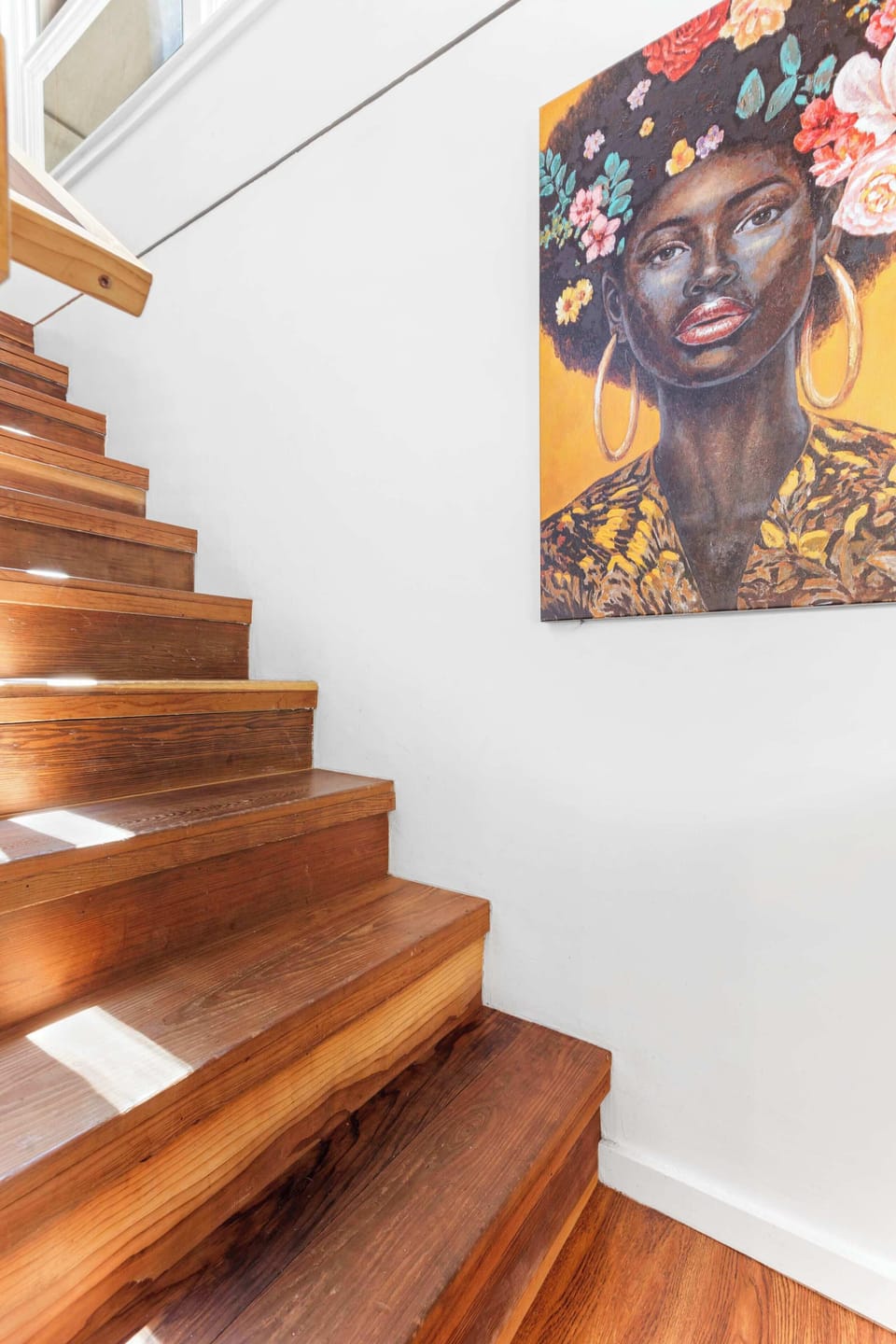 Descend the stairs from the living room and access the lower level primary bedroom with ensuite bath.