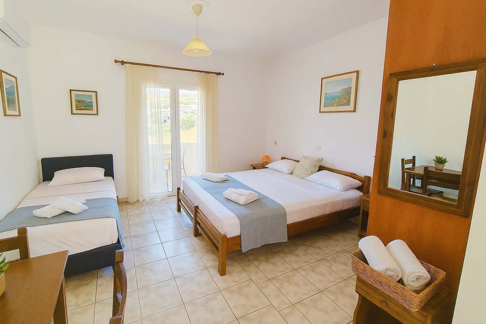Bedroom with Three Single Beds
Bright sleeping area with three single beds, perfect for friends or family.