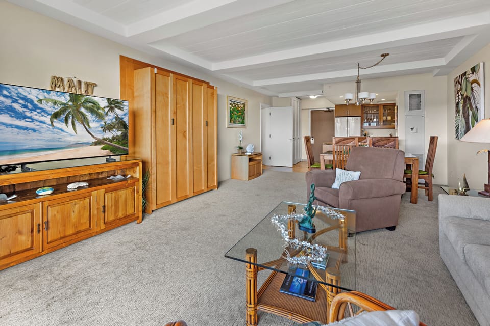 Unwind in a bright and welcoming living area, complete with a flat-screen TV and comfortable furnishings. Perfect for peaceful lounging.