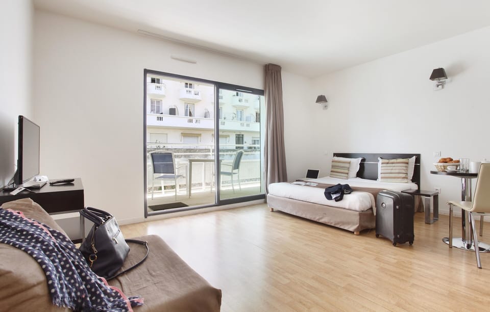 Wake up to natural light streaming through large windows in this airy, modern studio.