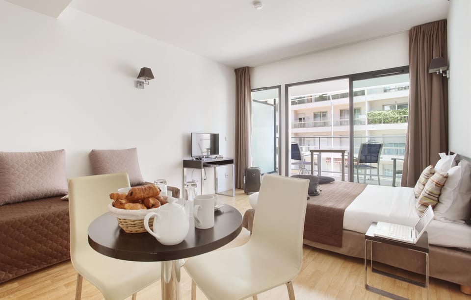 Share easy moments at the cozy dining table, perfect for casual meals or planning your day in Monaco.