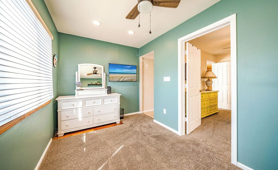 Spacious room with TV, ample closet space, and connecting doors.