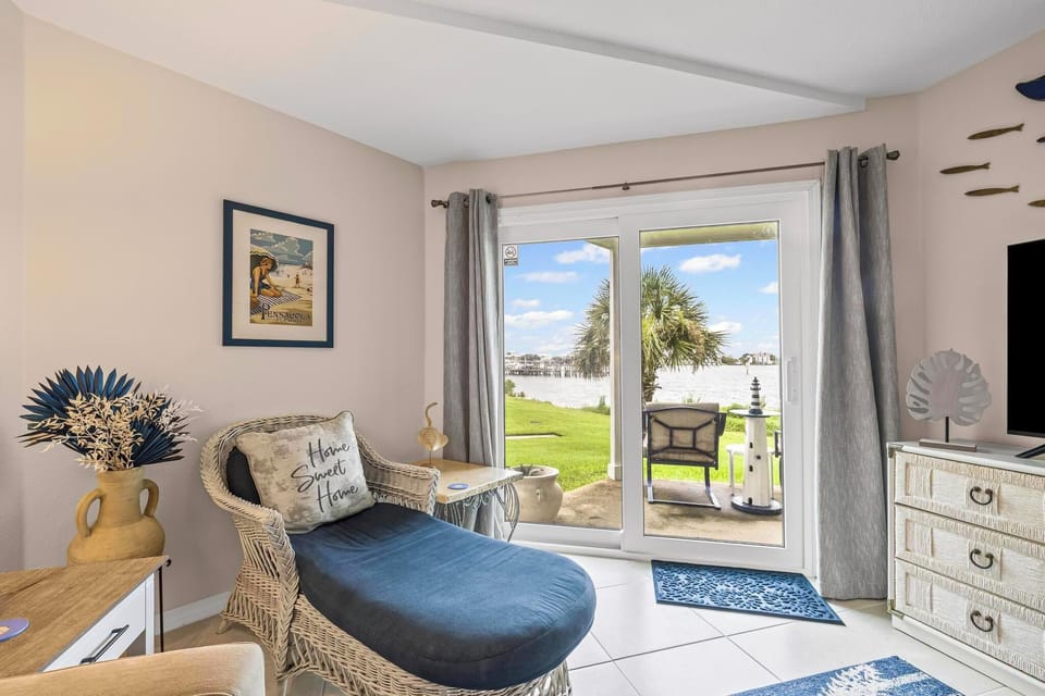 Cozy reading nook with chair, sea-themed decor, and lake views.