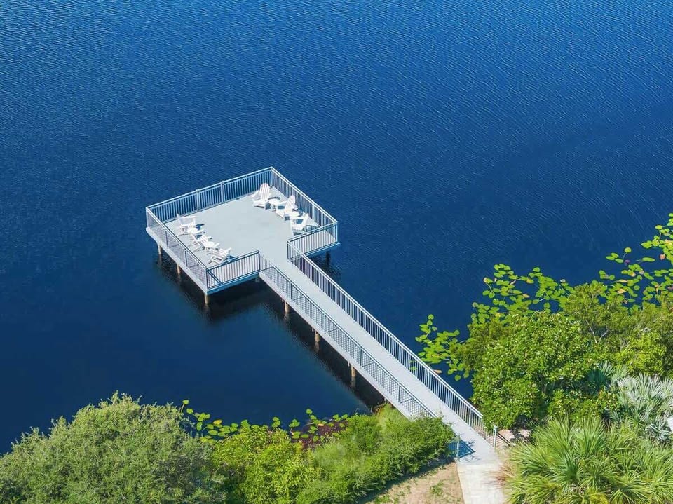 Home features an outdoor deck over the dune lake with seating, perfect for morning coffee and 30A sunsets.