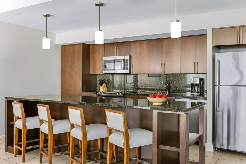 Gourmet kitchen stocked with utensils, dishes, glassware, and cookware