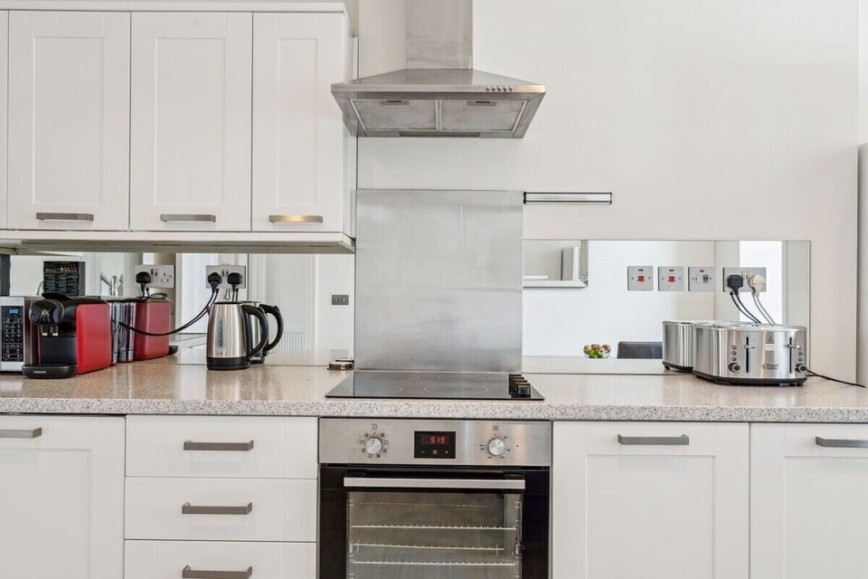 Fully equipped kitchen with modern appliances, cookware, and utensils—perfect for whipping up anything from a quick breakfast to a full dinner. Bright, clean, and ready for your stay.
