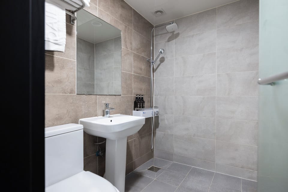Standard Double Room | Bathroom | Shower, hair dryer, bathrobes, slippers