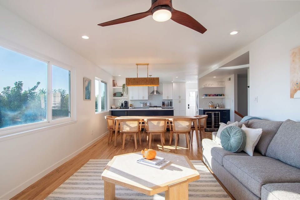 A bright, open living space designed for gathering—comfortable seating, a spacious dining area, and an easy flow into the kitchen.