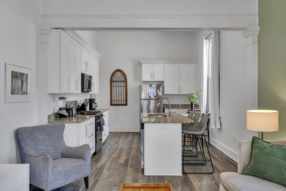 Spacious living room with plenty of seating, natural light, local artwork, and flat-screen TV w/ streaming channels