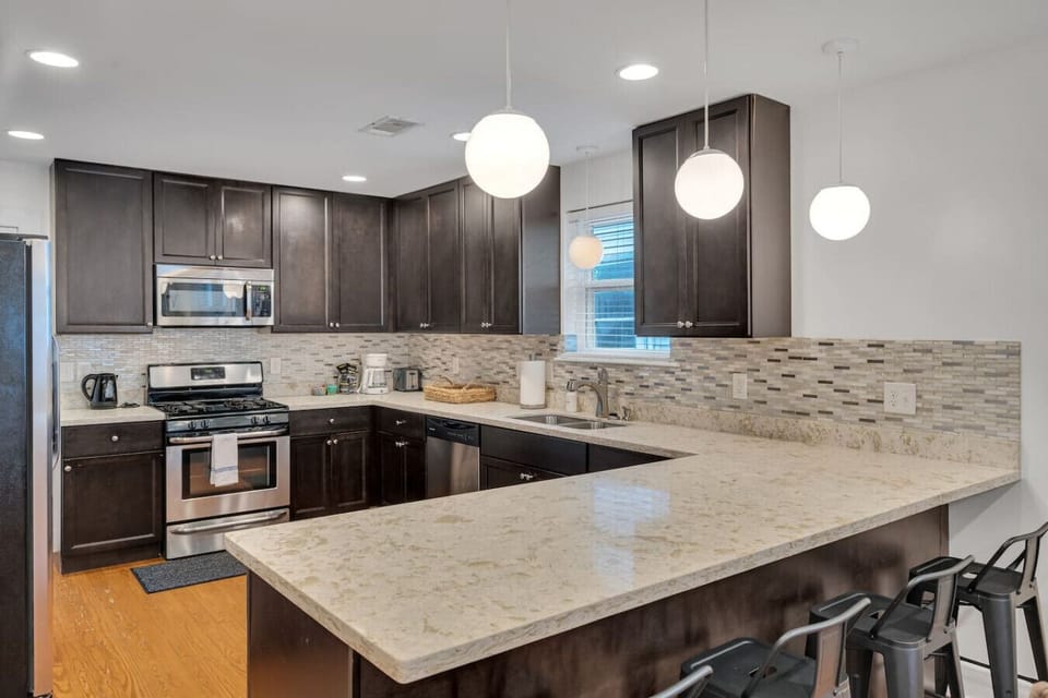 Kitchen space (open concept with living room area).  Fully outfitted with everything you need to whip up a meal!  Stainless steel appliances (gas stove, dishwasher, microwave, refrigerator)