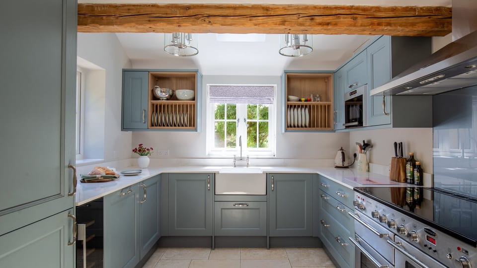 The traditional kitchen has been given a stylish twist with blue units and a fabulous range cooker