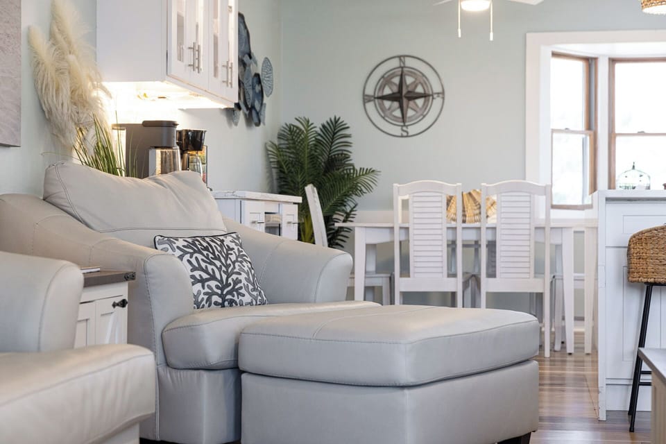 Bright coastal living space with comfy seating and airy dining area