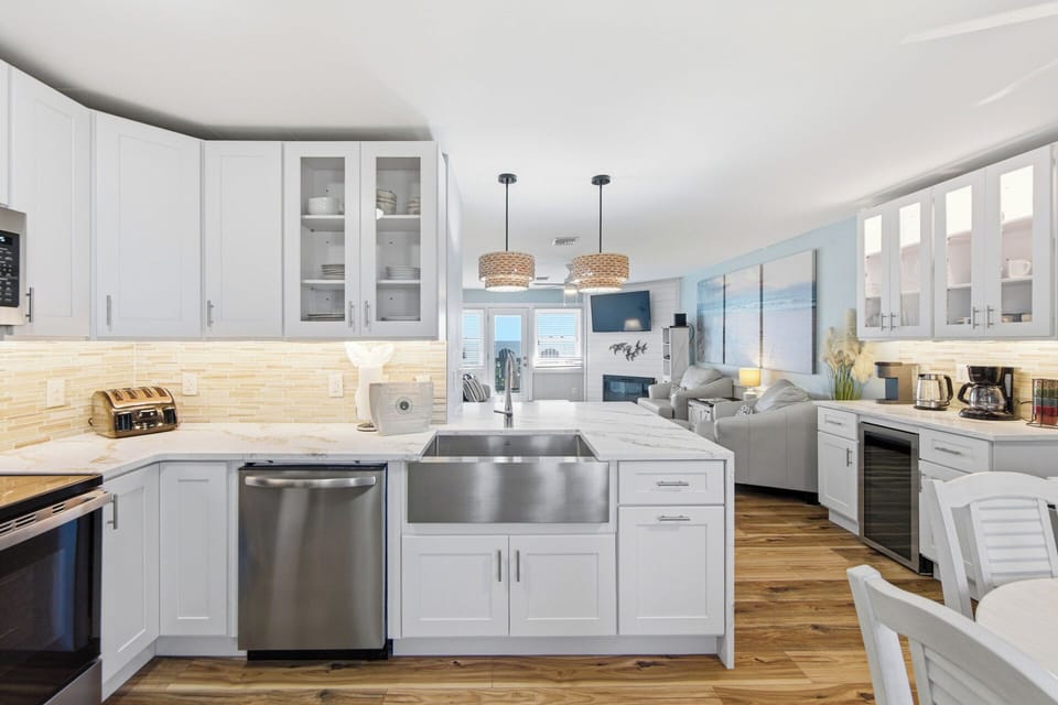 Bright coastal kitchen with farmhouse sink and open-concept living space
