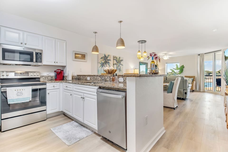 Your spacious kitchen features granite countertops, stainless steel appliances, and a breakfast bar perfect for morning coffee.