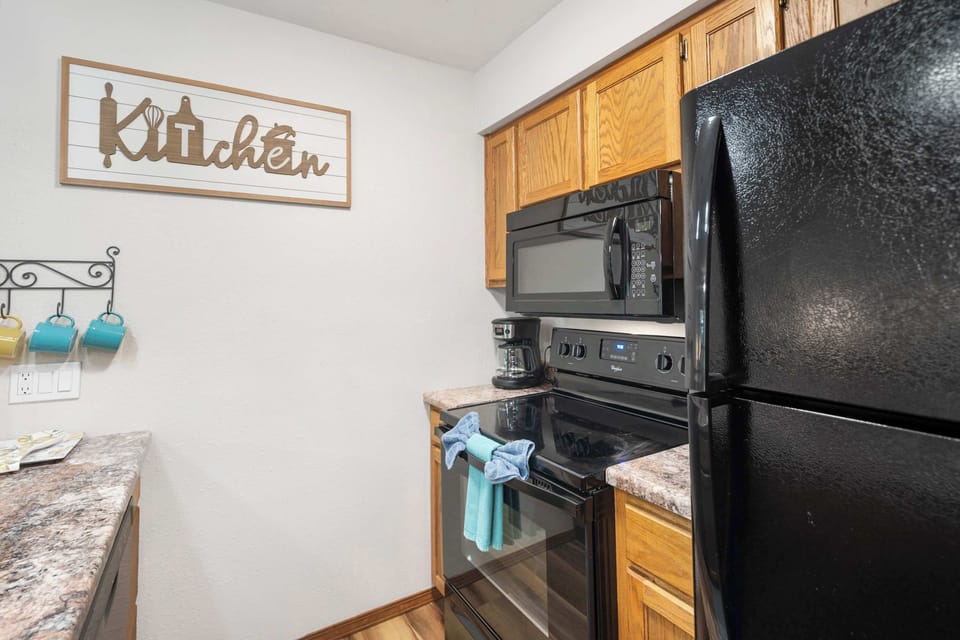 The open kitchen offers ample space & every home comfort