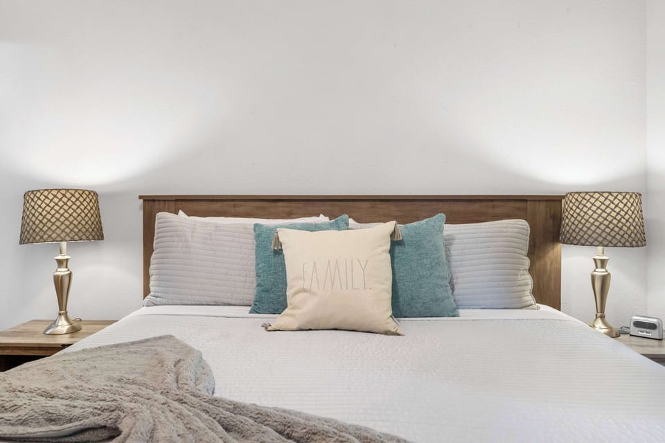 The primary suite features a king-sized bed, ensuite bath, & TV