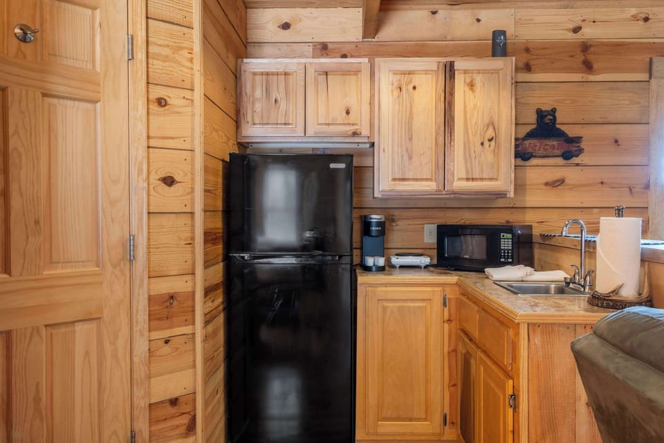 The open kitchen area offers ample storage & amenities for a great stay