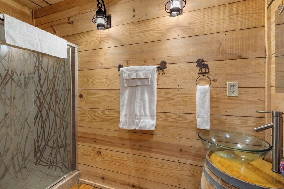 A single vanity & glass shower are available in the full bath