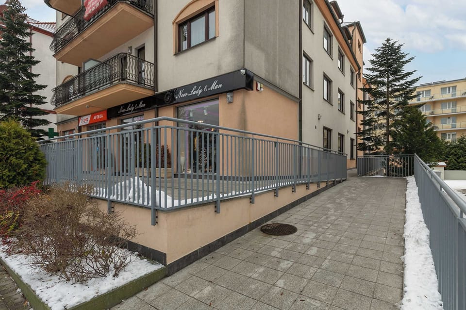 Property building situated close to the beach and near the park full of greenery.