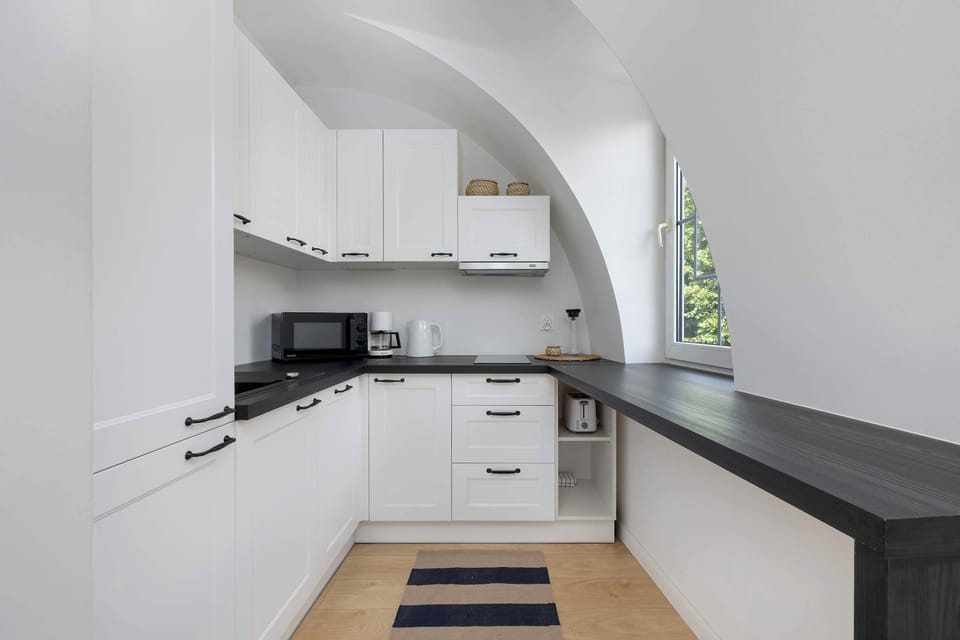 The sleek design of the kitchenette blending seamlessly with the living area.