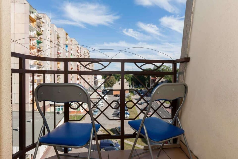 Spacious balcony with outdoor furniture. 
