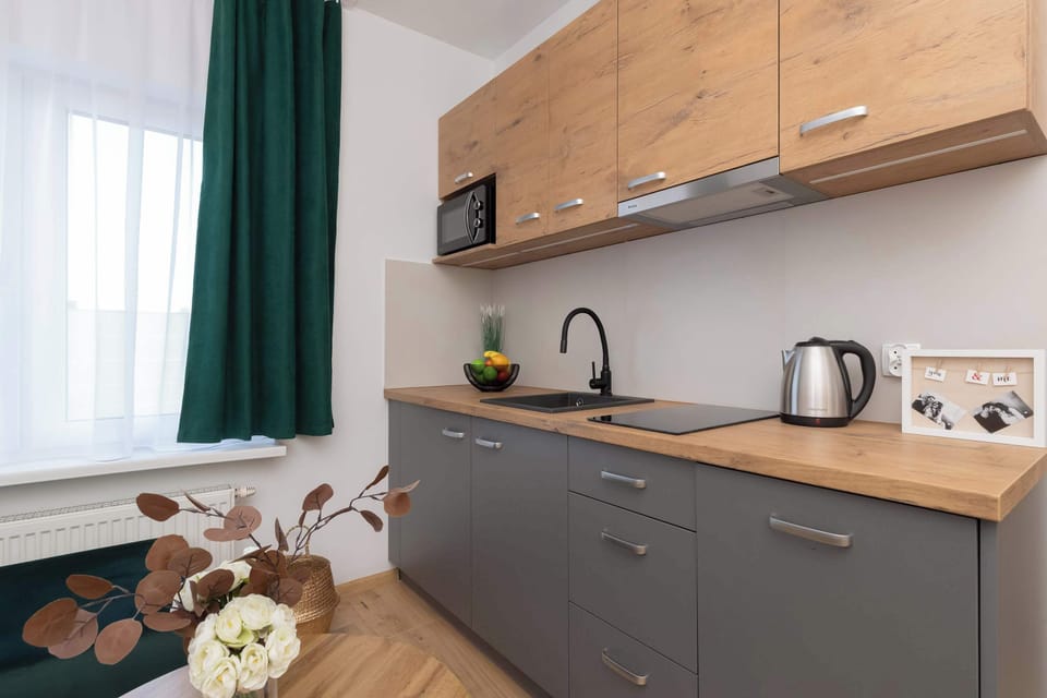 Fully equipped kitchenette with gray-brown cabinets.