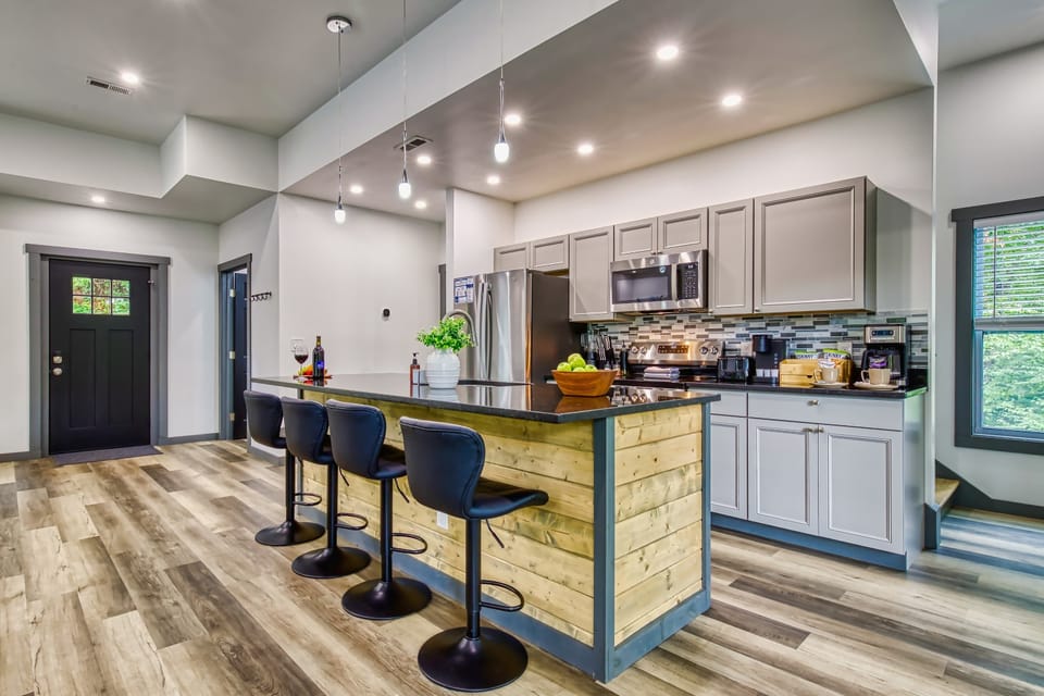 Cook like a pro in this fully stocked kitchen with granite counters, stainless steel appliances, and a 5-burner cooktop—just steps from the living room.