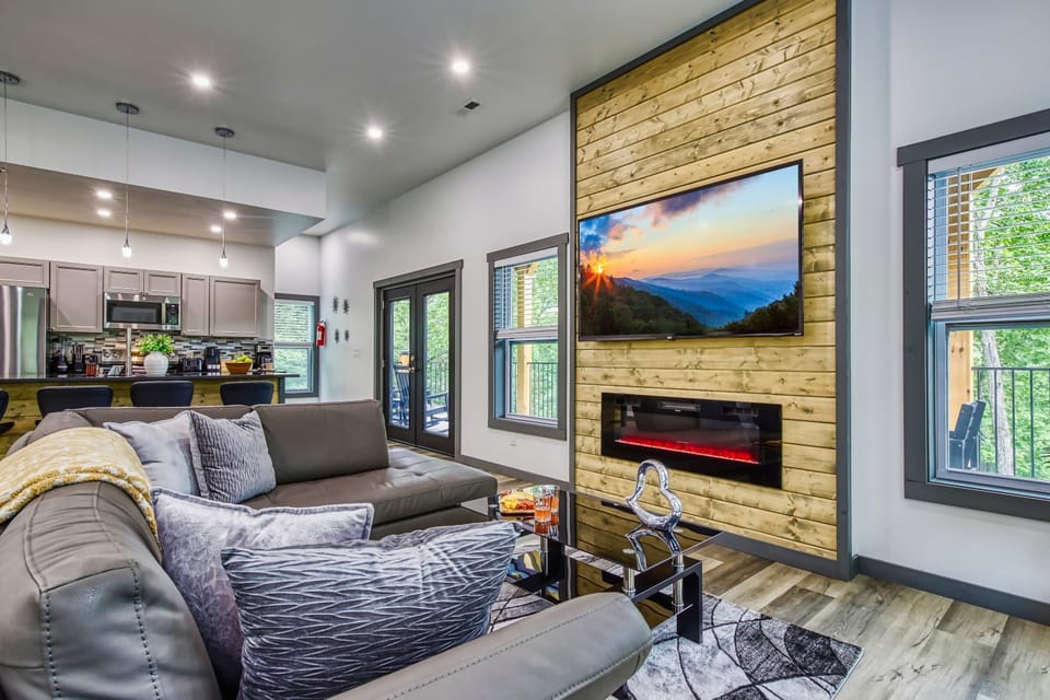 Relax in the spacious living area featuring a large leather sectional and open flow to the kitchen.