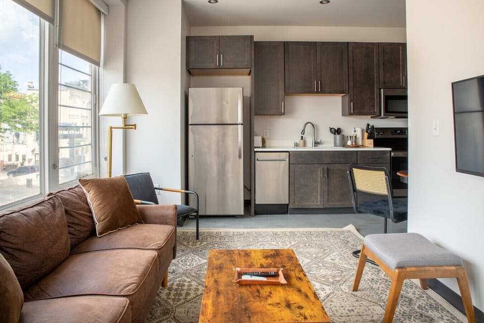 Sun-drenched living area featuring charming architecture and a front-row view of the Fiserv Forum.