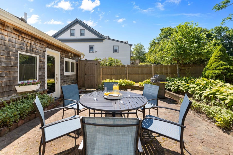 Private back patio! with a grill and outdoor furniture.