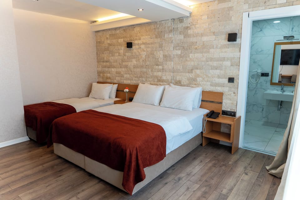 Premium Triple Room | Minibar, in-room safe, desk, laptop workspace