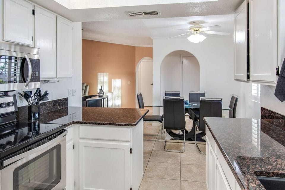 Kitchen with bar seating and open layout.