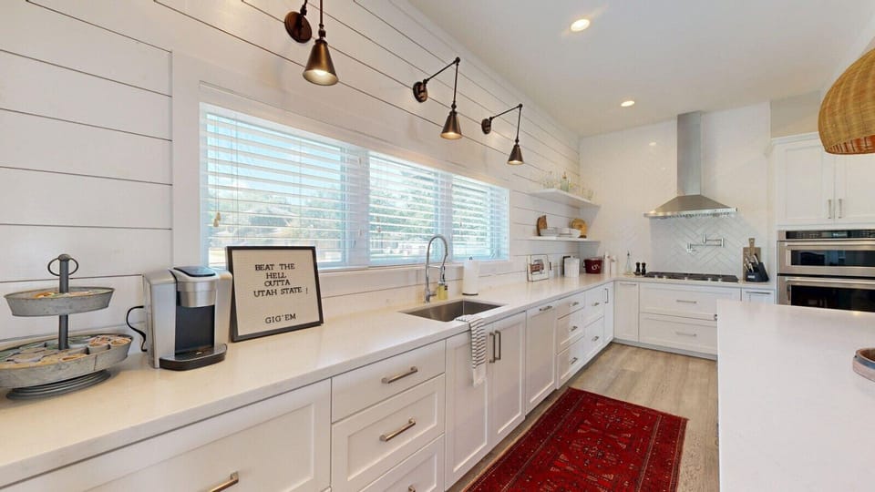 Abundant counter space enhances functionality in the beautifully designed kitchen.