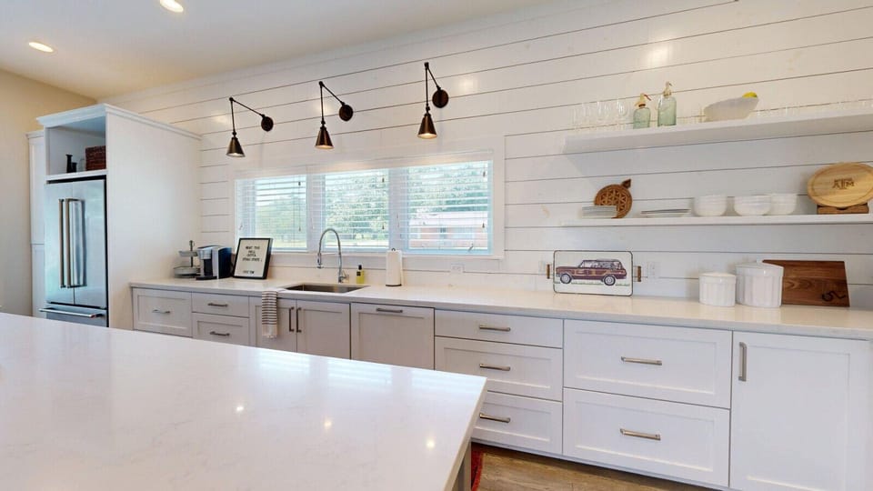 Abundant counter space enhances functionality in the beautifully designed kitchen.
