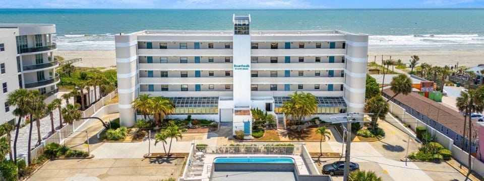 Aerial view of Boardwalk with an Outdoor pool and private beach access for guests to use!