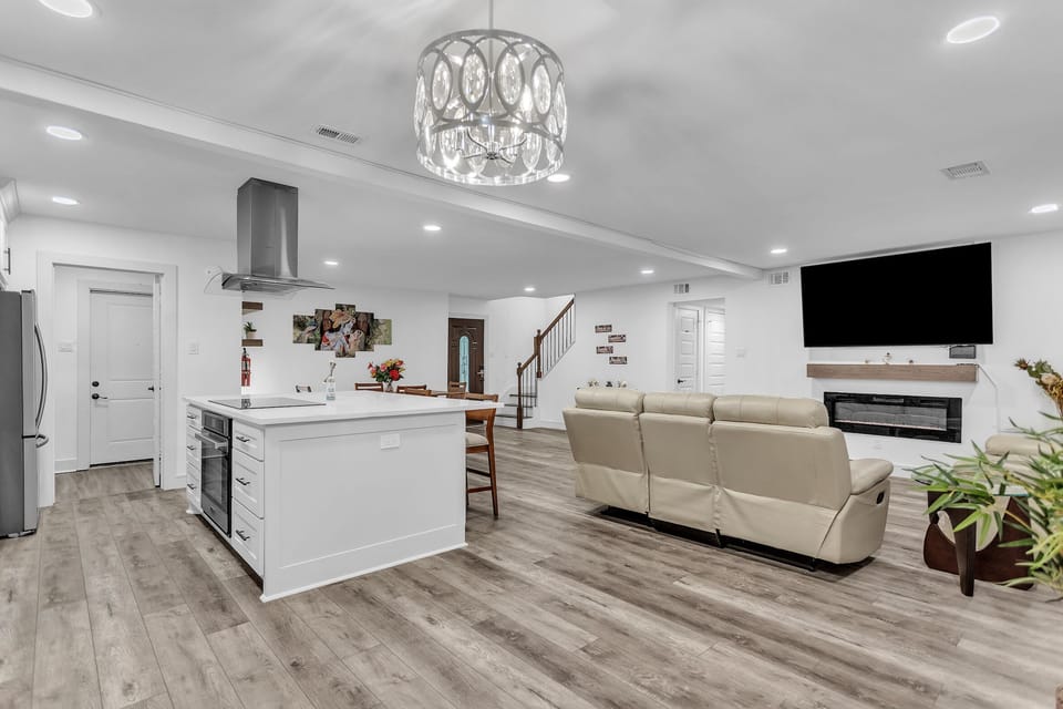 Living area with recliner sofas and 75 Inch smart TV. 