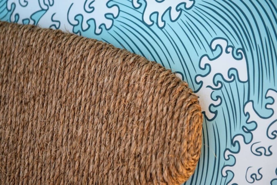 A hand-wrapped surfboard floats above the bed
