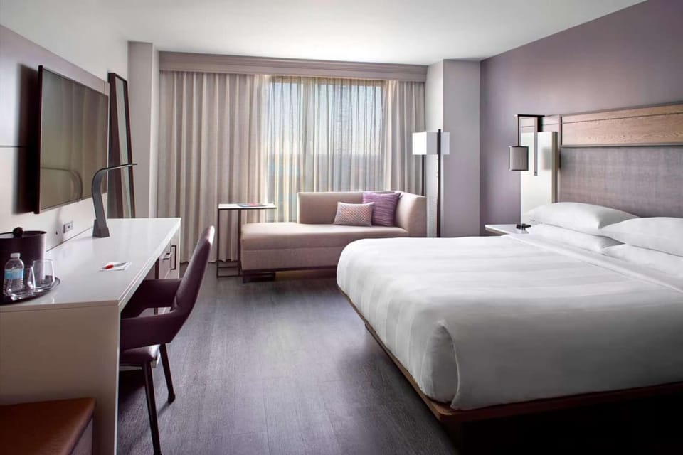 Spacious room with king bed, lounge, desk, and large window