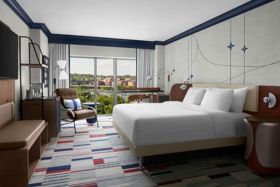 Superior King Room: Bright king room layout with accent chair, desk setup &amp; scenic window view