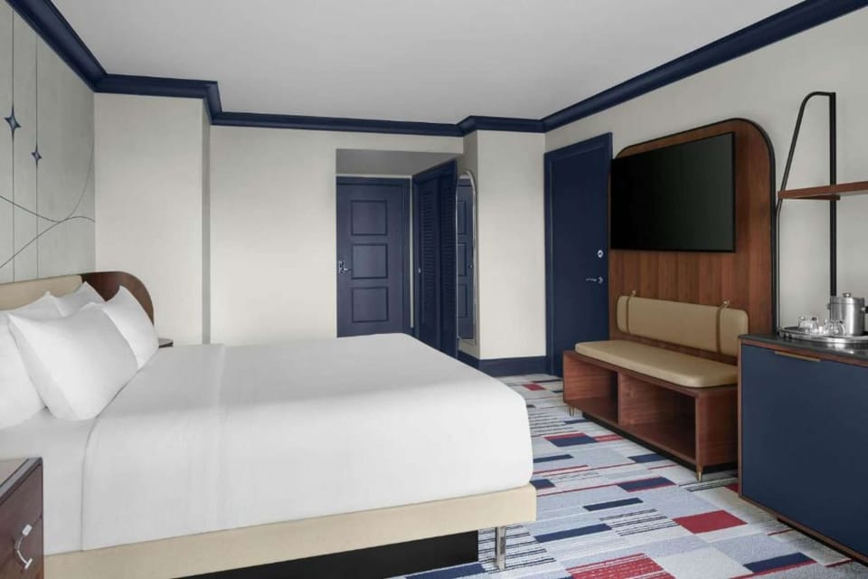 Superior King Room: King bed, bench seating, wall-mounted TV &amp; built-in refreshment station