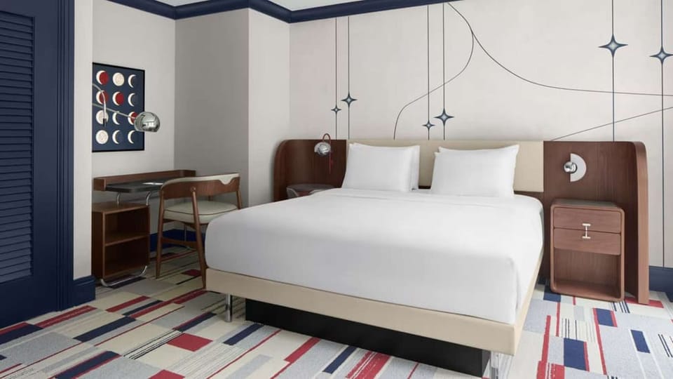 Executive King Room: King bed, sleek nightstands, desk nook &amp; modern geometric wall art