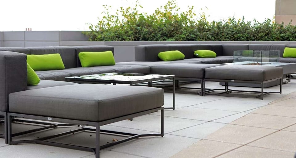 Outdoor patio with gray sectionals and bright green cushions